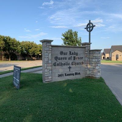 Sign for the Our Lady Queen of Peace Catholic Church.