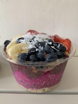 Build my own: half acai and half dragon fruit with vanilla nut granola topped with banana, blueberries, strawberries, coconut & honey