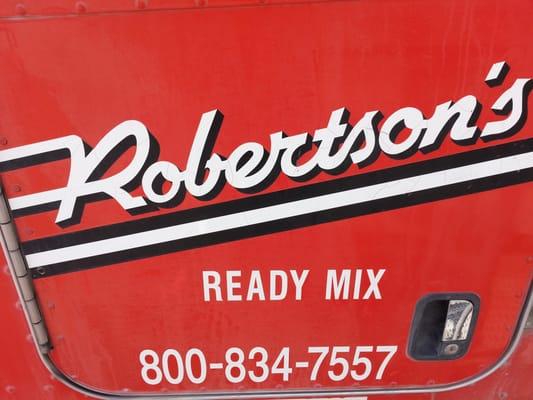 Logo and phone number on the side of a Robertson's truck.