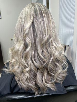 The subtle balayage highlights gracefully blend into her hair, adding dimension and a touch of natural radiance to her overall look