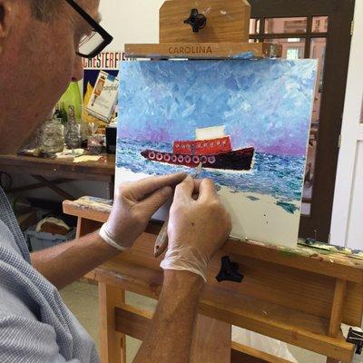 Cary Ferguson painting a nautical scene.