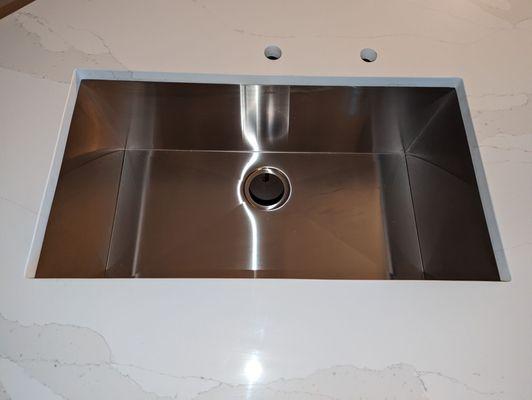 They hooked it up with an awesome stainless steel undermount sink as well (installers did a great job drilling holes for faucet/disposal)