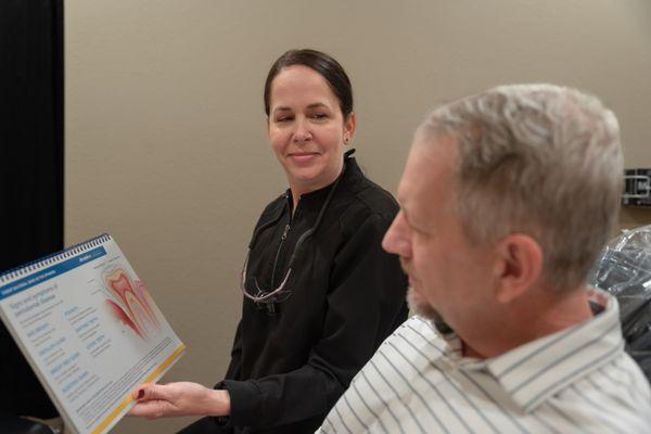 Our skilled hygienist speaking to a patient about periodontal disease