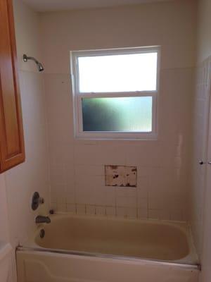 The tile walls were badly failing in this bathroom. The tiles were loose and beginning to fall off the walls...