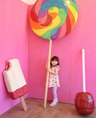 Cute Girl taking pictures with Fulton Boggs Giant candy sculpture at the POP LA event!