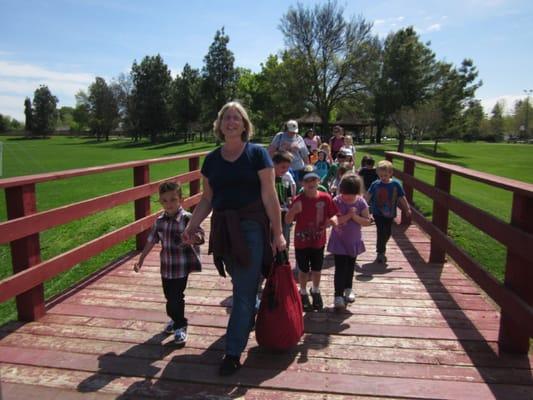 Older children at Bert & Ernies walk to a nearby park to enjoy a sack lunch picnic, game of baseball and fun in the playground.