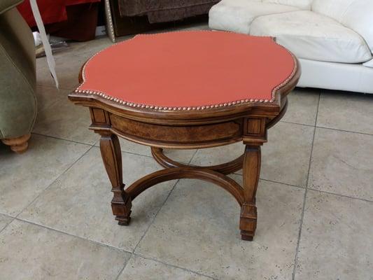 A nice leather top upholstered with decoration nails.