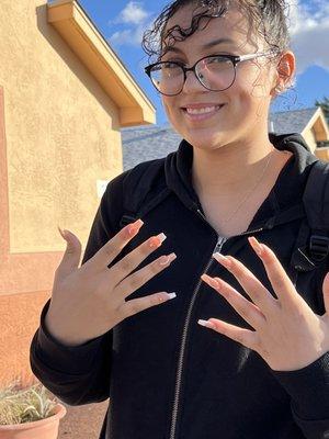 My Granddaughter after her nails were done, at Sparkle Nails.  She loved them!