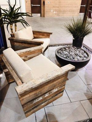 A close up of our reclaimed wood furniture + fire bowl at a trade show.