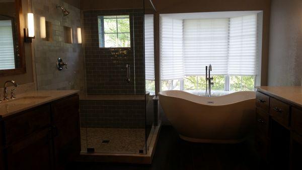 Side by Side Soaking Tub and Frameless glass surround shower.