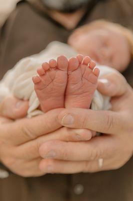 My husband's hands with those little feet!