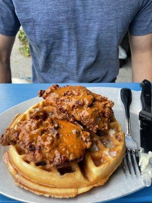 Fried chicken and waffle with Pterodactyl hot sauce, honey butter and cinnamon whiskey syrup