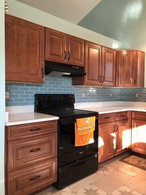 Kitchen wall repair, sub-floor repair, paint and backsplash tile.