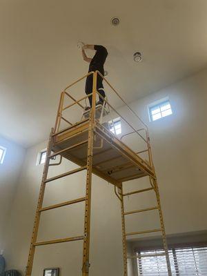 Helping a client change some lightbulbs to a 20" ceiling!