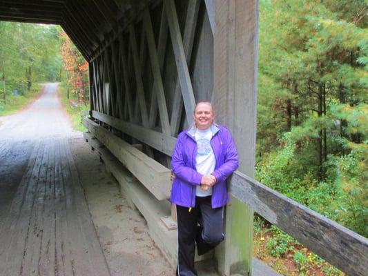 Scruffy person in front of the scruffy bridge