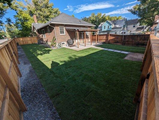 Full backyard makeover. Fence, Metal edging, walkway, sod, rock, concrete patio and a new irrigation system.