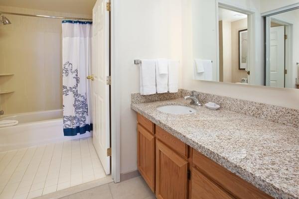 Suite bathrooms are highlighted by granite countertops and complimentary toiletries. Accessible bathroom options are available.