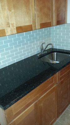 My granite is so smooth, no rough spots, look at that shine (the glass tiles are reflecting on the stone :) & beautiful undermount sink