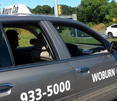 Notice the "No Smoking" sign in front of the passenger seat and the cigarette drooping from the driver's mouth.