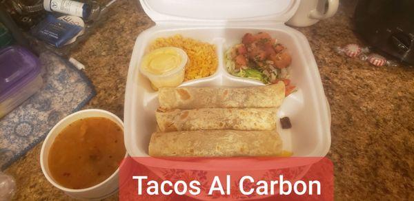 Tacos al Carbon: Charred Beef Steak wrapped in Tortillas with Spanish Rice, Cheese Sauce, Charro Beans and Pico de Gallo.