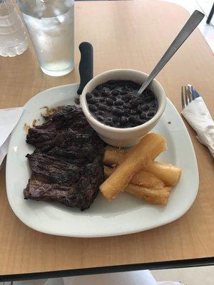 Churrasco in special lunch with black beans and yuca fried.