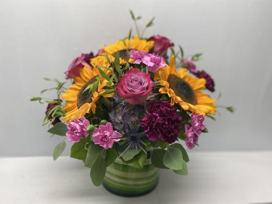 Sunny sunflowers and purple roses are sure to brighten anyone's day! Send Flowers make someone happy!