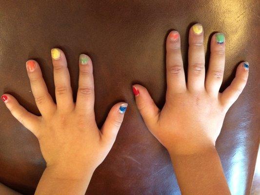 A young student's hands with color-coded finger nails ready for playing songs from the Musicolor Method!