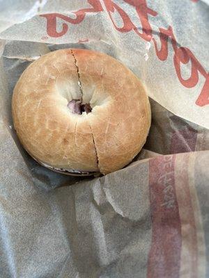 Plain bagel with strawberry cream cheese.