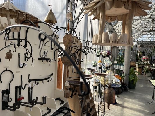 Variety of plant hangers and hooks in the greenhouse