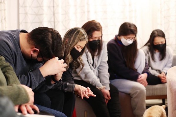 Members of a Cherry Hill community group praying together.