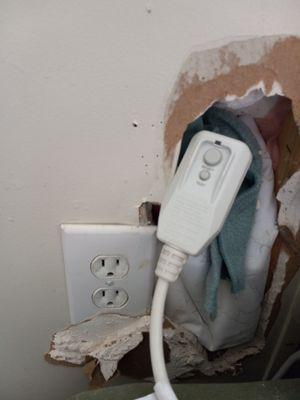 Ac plug next to hole in wall- unsafe!