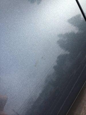 Dirt left on car after cleaning.