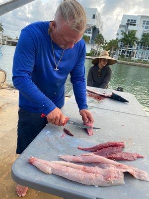 Captain Bryan slicing our catch