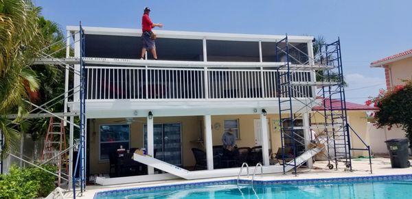 Constructing a pool cage on Albatross St., Ft Myers Beach.