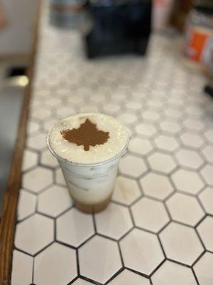 Vanilla latte with Cold foam and coco powder leaf topping