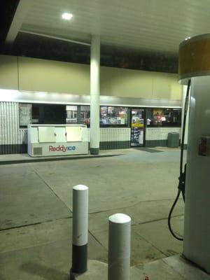 Main entrance to the right of the gas pumps.