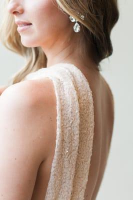 Colette - a blush wedding dress with high neck and open back.