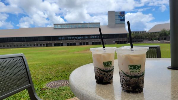 Enjoying 2 Iced Cloud Coffee Drinks in front of A building.