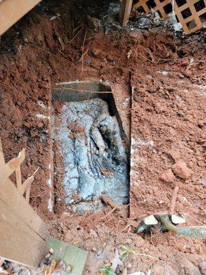 Overfilled septic tank with rotted outlet baffle tee