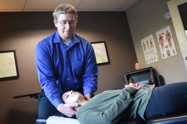 Dr. Larson giving a chiropractic adjustment.