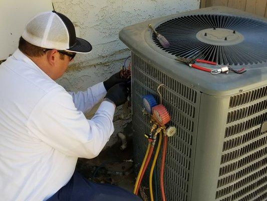 Chris is doing a maintenance on a system.This will help make a system more efficient and cost less to run.