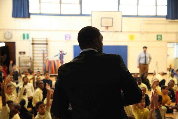 Edmond Laryea, a motivational speaker, addresses his audience of 3rd graders in New Jersey.