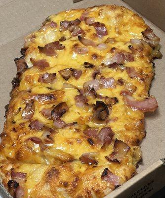 This flat bread is spread with butter, cover with Cheddar, top with Smoke Hickory Bacon and drizzle with Maple Syrup