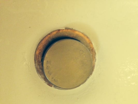 New drain cap discolored as if he wiped with a chemically soaked rag.