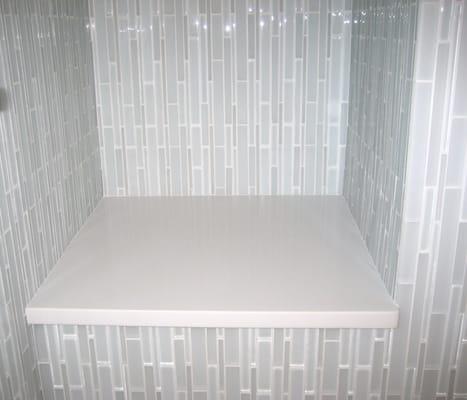 This is a linear glass tile installation in an upper level roll in shower.