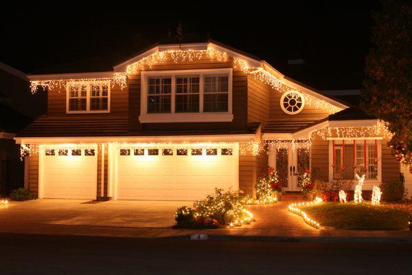 A classic.. Clear icicles with mini lights in the garden and stake lighting outlining the walkway