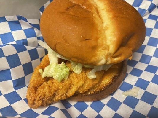 Golden Fried Chicken Breast on a toasted Brioche Bun, with lettuce, tomatoes, pickles, onions, & secret sauce