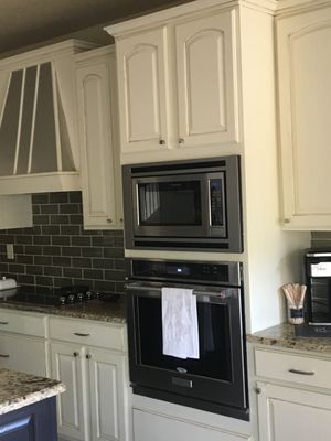 Wood cabinetry transformed into clean ivory cabinetry