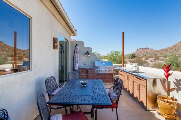 Expanded their outdoor living space with an outdoor kitchen and living area under a revamped purgola.