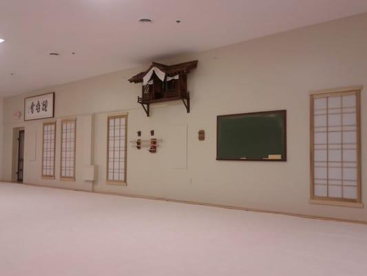 Front of the dojo, the largest training facility I've ever seen. Very clean. Screen windows and shrine give an authentic feeling.